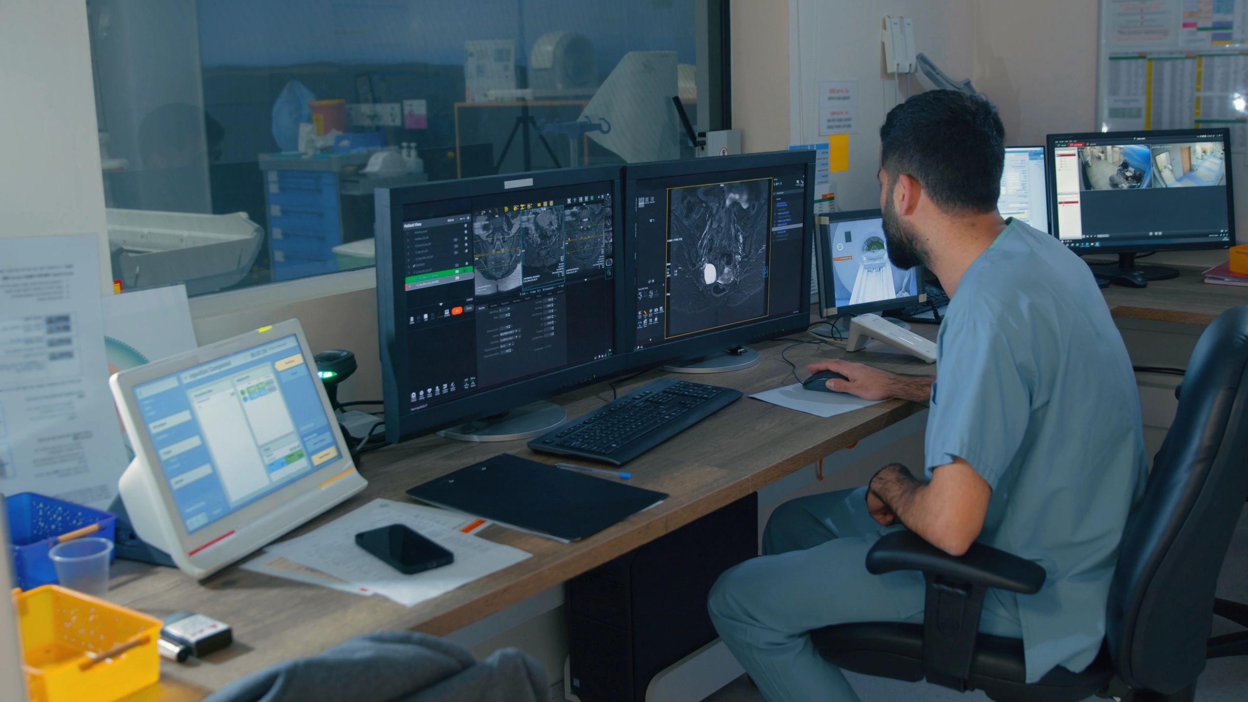 Clinician reviewing medical imaging and data on a computer.