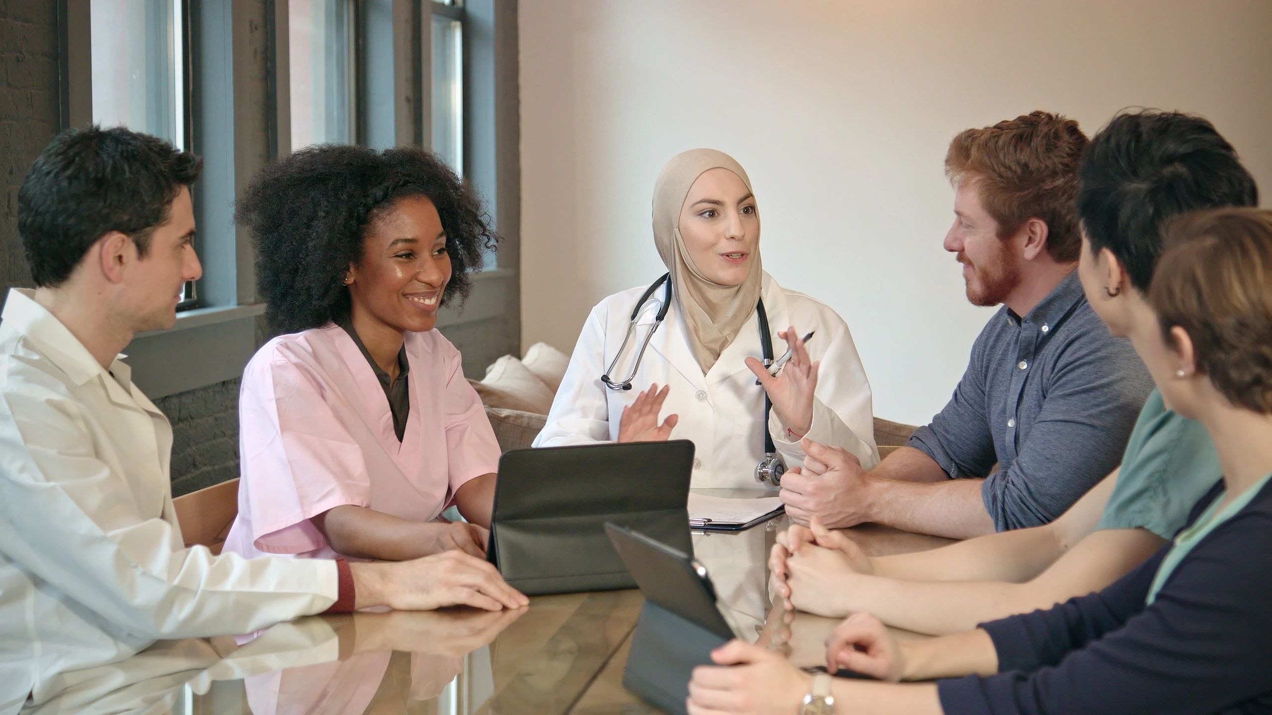 Physician meeting with healthcare professionals